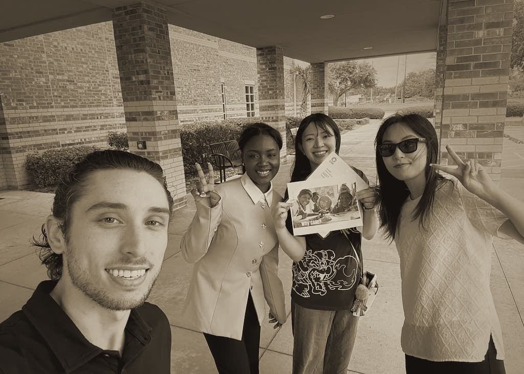 A fundraising team smiling together outside a venue.