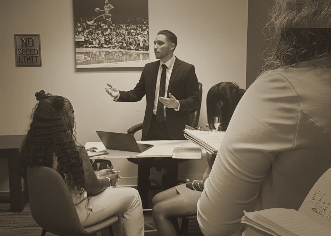 A leader coaching a small group in the office.