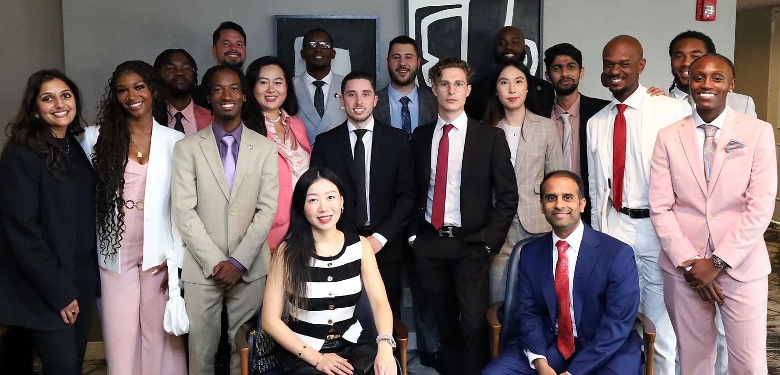 Xichen Mao and Zach Pyron with their team, about twenty people in business dress, two seated in front.