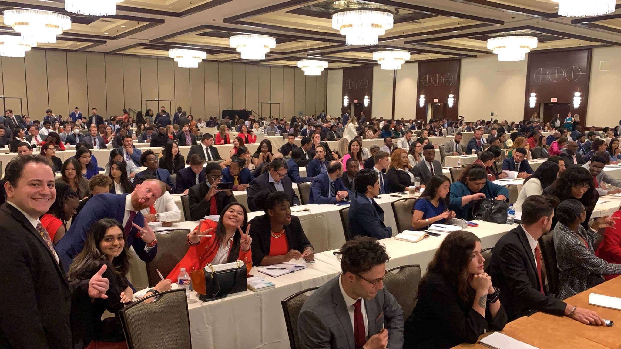 Attendees seated at rows of tables in a large conference room during client training in Orlando in 2025.