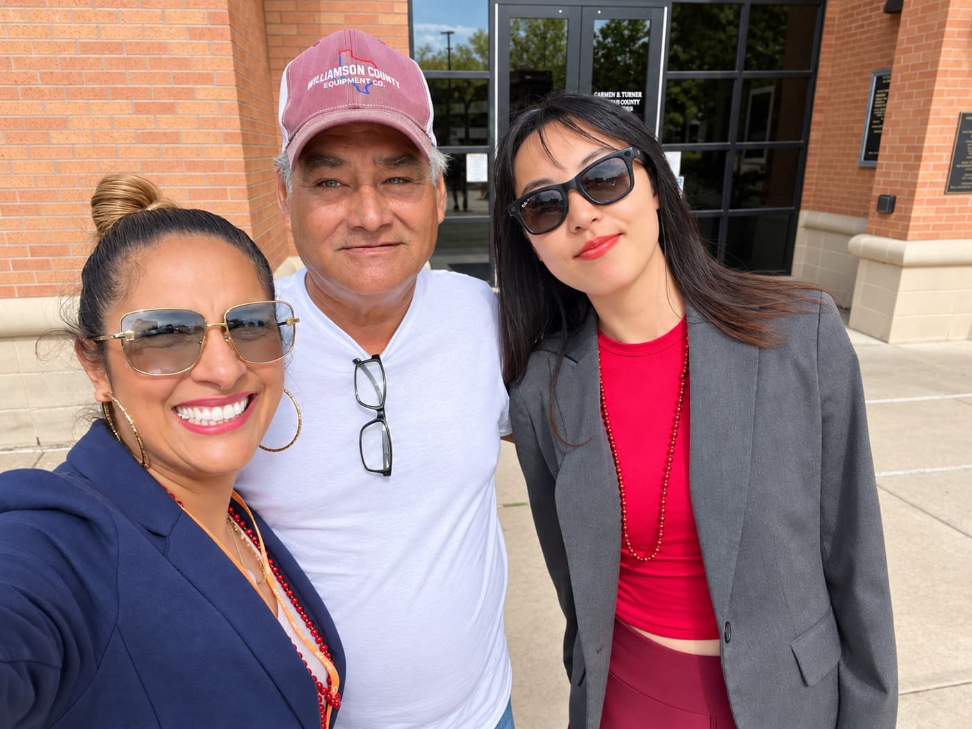 A fundraiser and two supporters outside a county office entrance