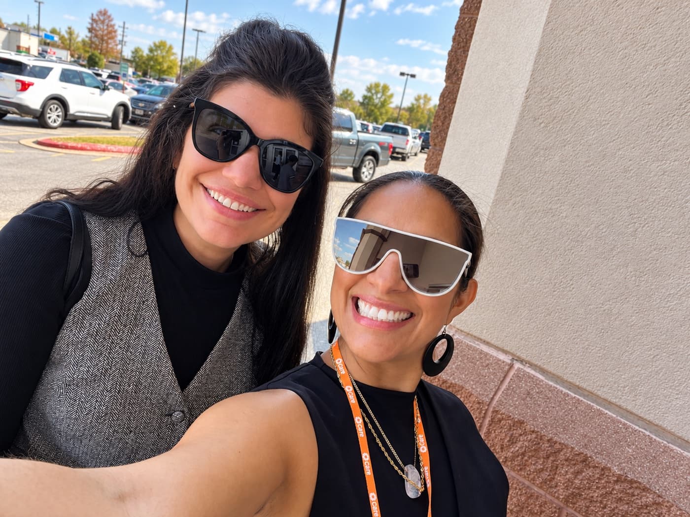 A fundraiser and a supporter smiling outside a shopping center